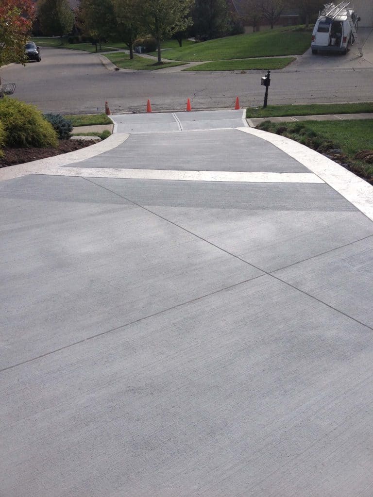 Control joints cut into a new concrete driveway, a key topic among the questions to ask a concrete contractor